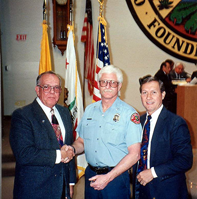 Mike receiving his 25 year pin from the Mayor and Chief
