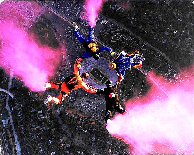 Mike (in orange) and friends performing a demonstration jump into the Rose Bowl. Notice the center of the formation.